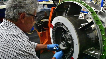 A technician works on an aircraft engine at Honeywell's facility in Phoenix.